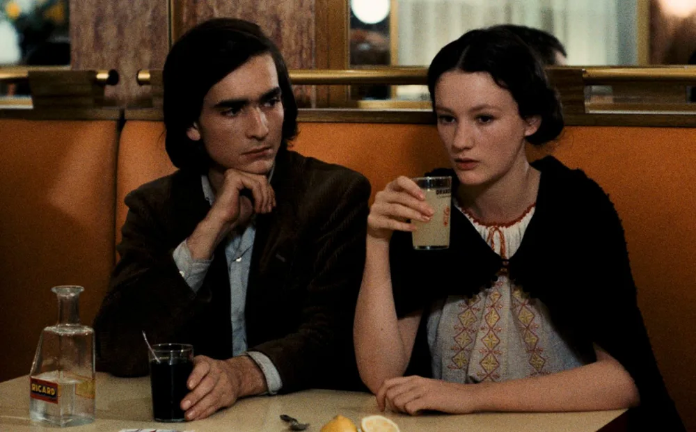 From "Four Nights of a Dreamer," Robert Bresson's 1971 film: a lonely young man and woman (des Forêts and Isabelle Weingarten) sitting in a booth in a diner. He is looking at her, but she is staring straight ahead.